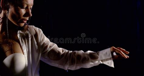 Woman Is Wearing White Lingerie And Unfastened Shirt Is Moving Hands Under Rain In Night Street