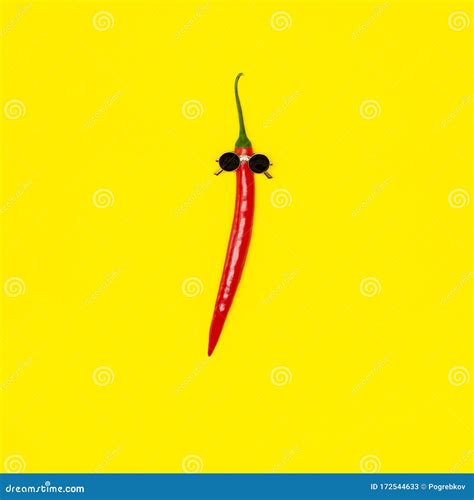 Red Chili Pepper In Sunglasses On Yellow Background Hot Summer Party Creative Concept Stock