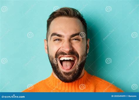 Headshot Of Happy And Carefree Man With Beard Laughing And Looking At