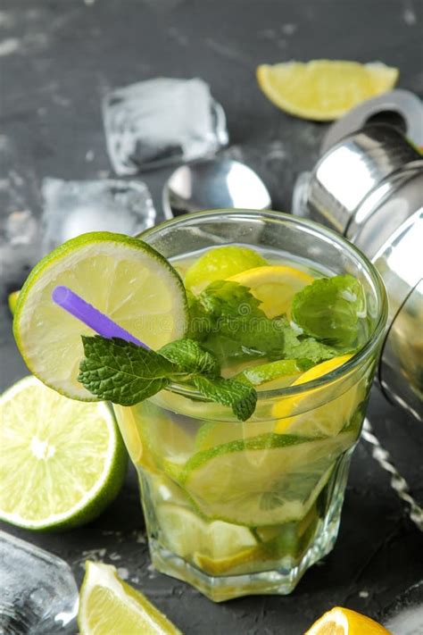 Mojito Cocktail In A Glass Glass With Lime Mint And Lemon And Bar Accessories On A Dark