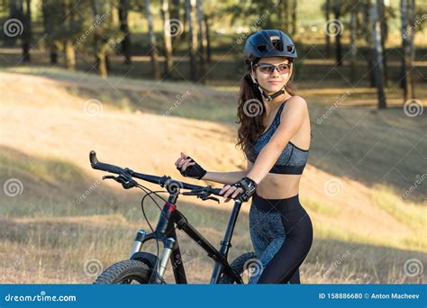 Girl On A Mountain Bike On Offroad Beautiful Portrait Of A Cyclist At