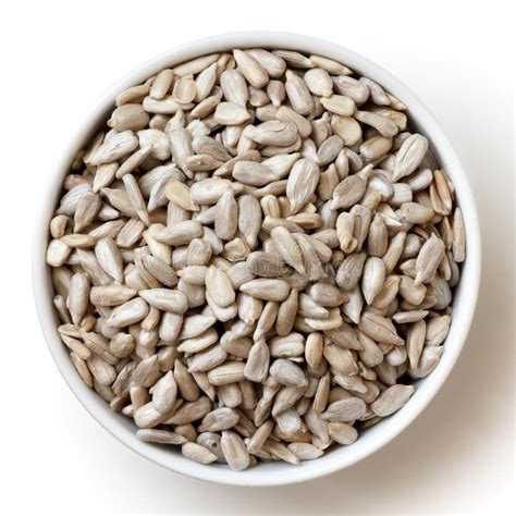 shelled sunflower seeds  small white bowl isolated   stock