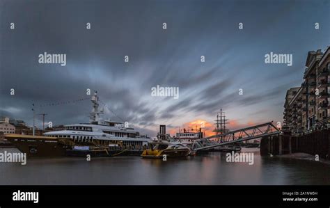 Golden Superyacht Moored On The River Thames At Sunset In London Stock