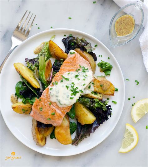 Salmon with roasted potatoes, field greens salad and chive creme ...