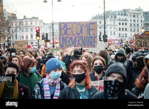 A Protester Holds A Placard Expressing Her Opinion During The