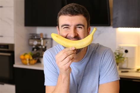 Cheerful Man Covering Mouth With A Banana Stock Image Image Of