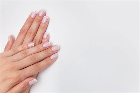 Premium Photo French Manicure Nude Nails Covered With Gel Polish On A White Background