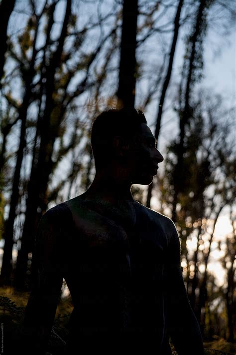 Silhouette Of Semi Naked Man With Body Art And Sunlight Defining