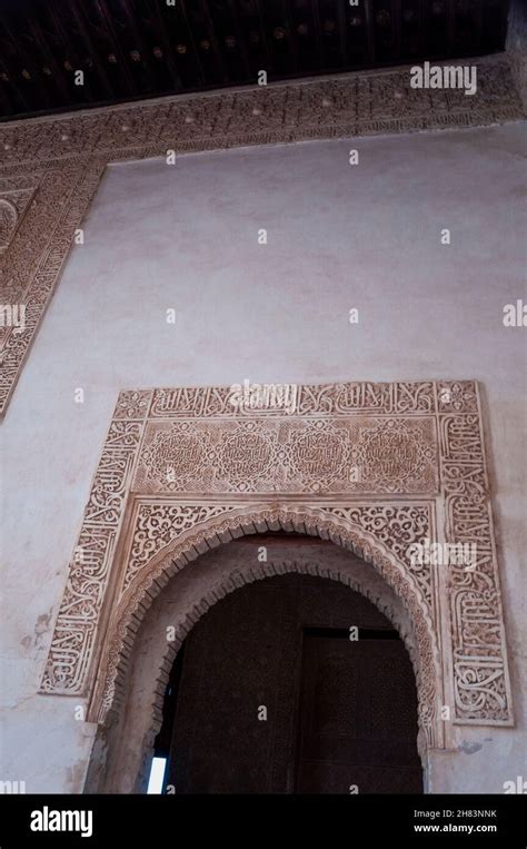 Arabesque patterns above a toothed horseshoe arch at La Alhambra, a popular tourist attraction ...