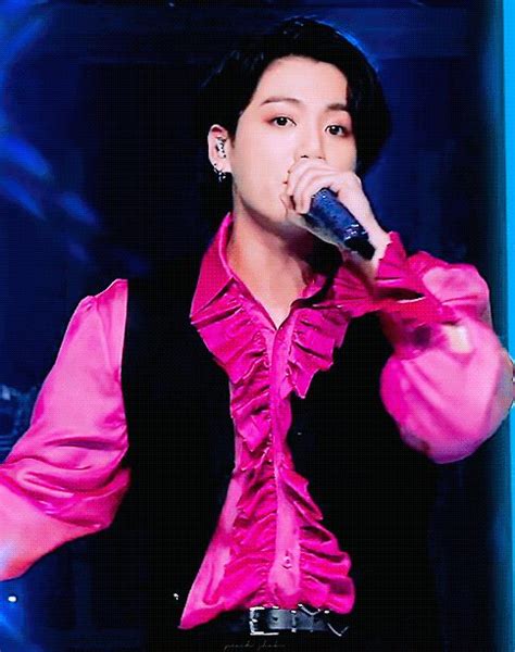 Male In Pink Shirt Holding Microphone