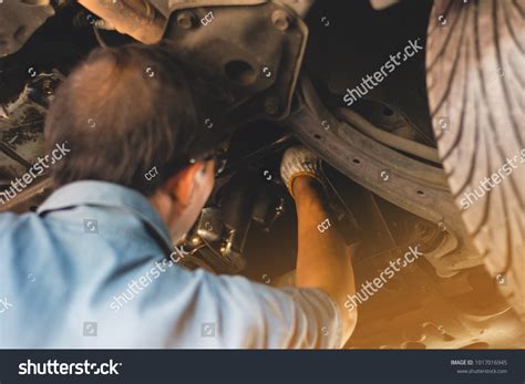 Mechanic Uniform Lying Down Working Under Stock Photo 1017016945