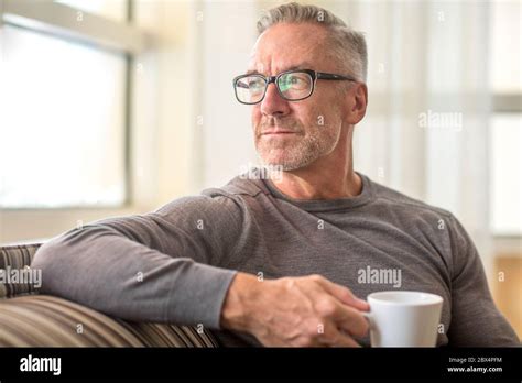 Mature Man Sitting On A Sofa Sock Photo Stock Photo Alamy