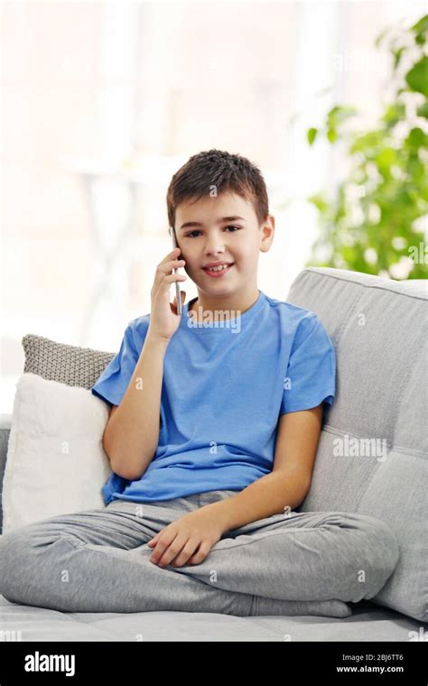 Boy Using His Mobile Phone At Home Stock Photo Alamy