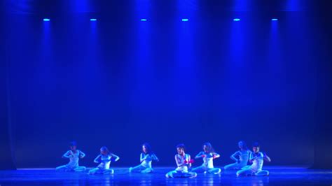 Silhouetted Dancers On Stage With Blue Lighting Performing A