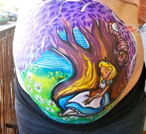 A Pregnant Woman With Her Belly Painted To Look Like Alice And The