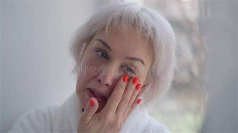 Close Up Portrait Mature Woman Rubbing Moisturizer On Face Skin Looking In Hand Mirror Adult