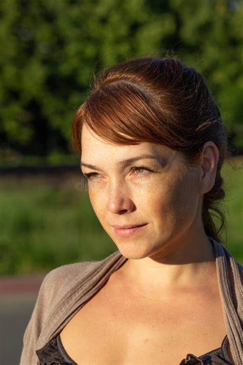 Portrait Of Beautiful Serious Middle Aged Woman With Calm Face Looking