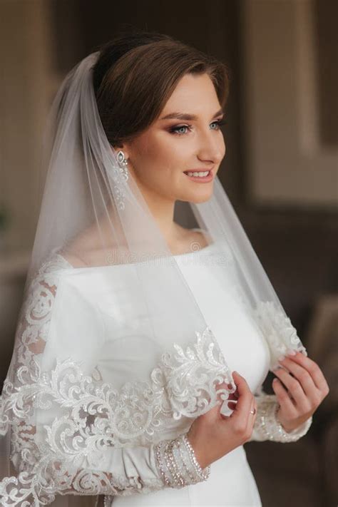 Portrait Of Beautiful Bride Standing By The Window At Home Charming