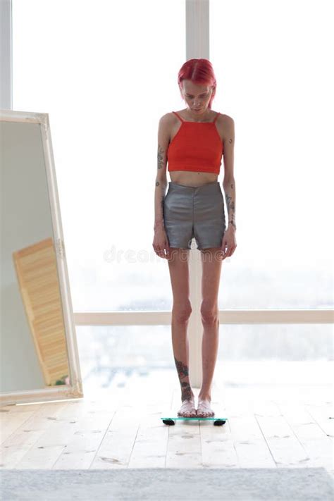 Extremely Skinny And Slim Anorexic Woman Looking Into Mirror Stock