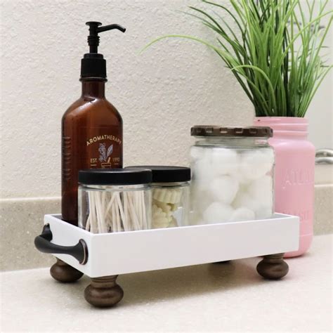 A Bathroom Shelf With Soap Toothbrushes And Other Items On It Next To