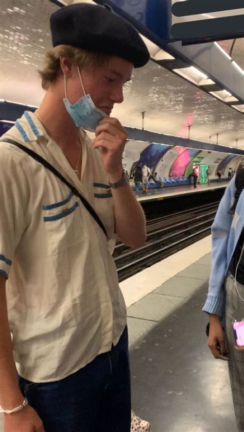 Two People Wearing Face Masks At An Airport