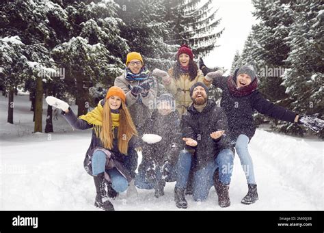 Group Photo Of Happy Young Men And Women Having Fun In The Snow In A