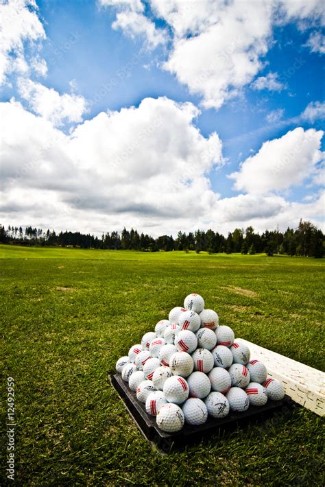 Golf ball pile at driving range Stock Photo | Adobe Stock