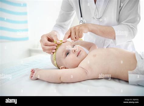 professional pediatrician examining smiling baby stock photo alamy