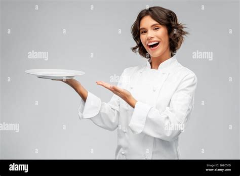 Smiling Female Chef Holding Empty Plate Stock Photo Alamy