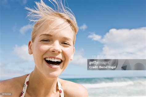 Laughing Young Woman On Beach High-Res Stock Photo - Getty Images