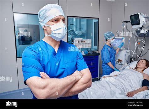 Medical Team Of Intensive Care Unit Attending To Female Patient Lying Of Hospital Bed Icu Stock