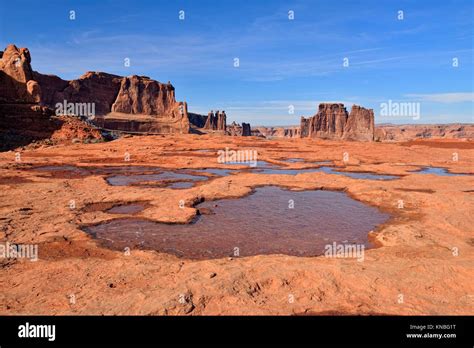 Courthouse Towers And Puddles With Ice In The Red Rock Arches National