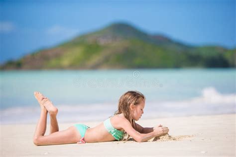 Menina Adorável Na Praia Que Tem Muito Divertimento Na água Pouco