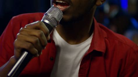 Close Up Shot Of Young Black Man Using Microphone When Singing Karaoke