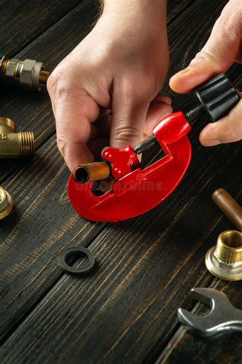 Cutting A Copper Pipe With A Pipe Cutter In The Hands Of A Master