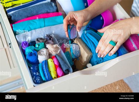 Neatly folded clothes with accessories in chest of drawers Stock Photo: 163569319 - Alamy