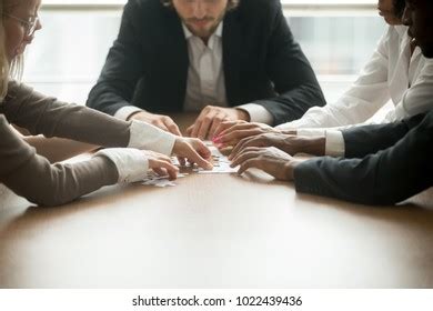 Multiracial Business Team Assembling Jigsaw Puzzle Stock Photo