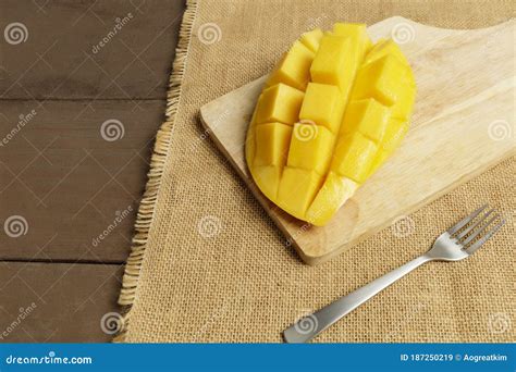 Yellow Half Mango With Small Fork Mango Fruit Cubes On The Wooden