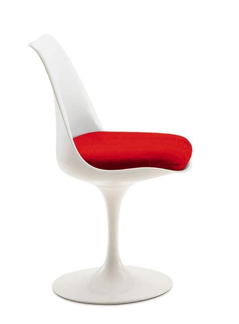 A White Chair With A Red Cushion On The Seat And Back Rest In Front Of