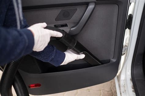 Premium Photo | Female hand in white gloves hoovering a car cabin