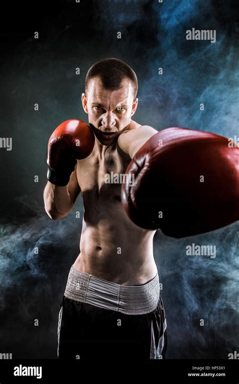 Muscular Kickbox Or Muay Thai Fighter Punching In Smoke Stock Photo Alamy