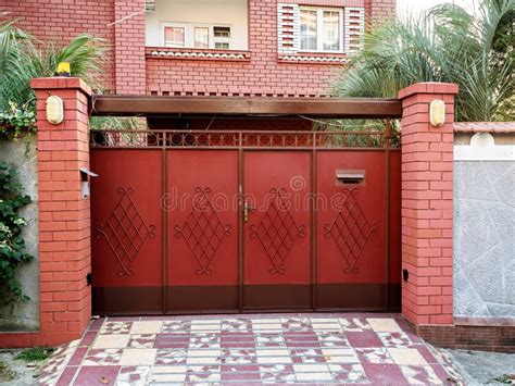 Beautiful Red Gates With Forging Elements On The Background Of The