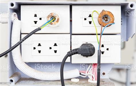 Electronic Power Plug With Unsafety Plugged In Wall Socket Stock Photo - Download Image Now - iStock