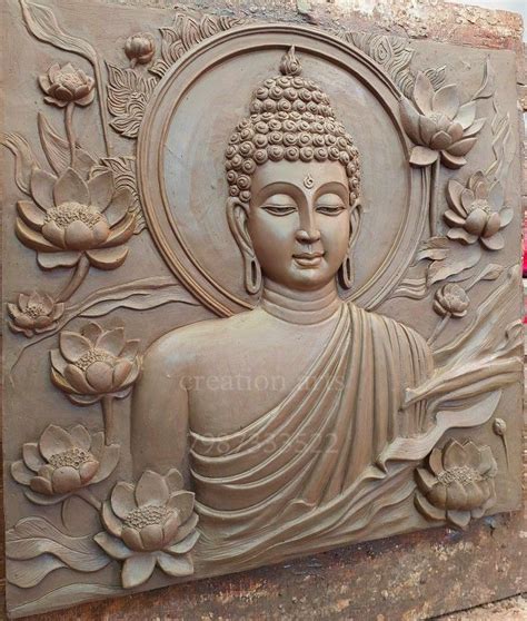 A Buddha Statue Sitting On Top Of A Stone Wall