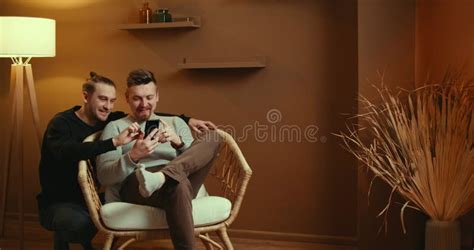 Cute Male Gay Couple Spend Time Sitting Chair Floor Use Smartphone Stock Footage Video Of