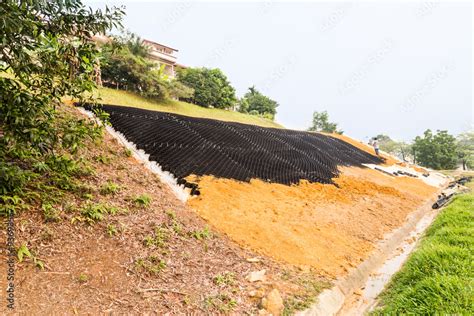 Slope erosion control with grids and earth on steep slope Stock Photo ...