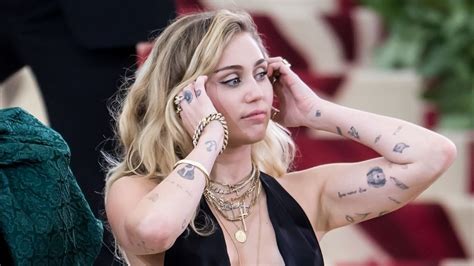 tattoos miley cyrus   liam hemsworth   meaning yaay