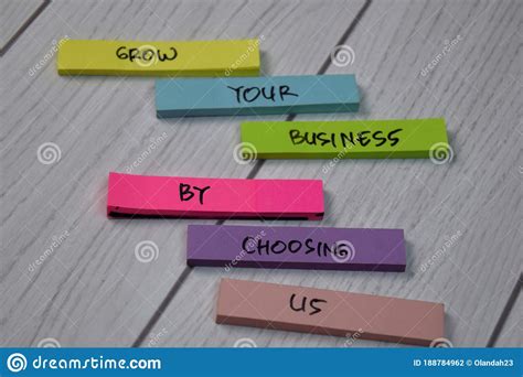 Grow Your Business By Choosing Us Text On Sticky Notes Isolated On