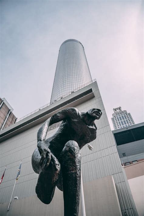 Sculpture Against Skyscraper · Free Stock Photo