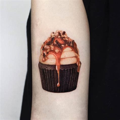 Micro Realistic Style Cupcake Tattoo Located On The